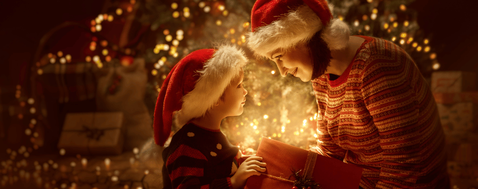 Mom and son looking into an illuminated gift box